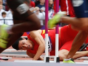 China's Liu Xiang falls after hitting a hurdle in his men's 110m hurdles round 1 heat during the London 2012 Olympic Games at the Olympic Stadium in this August 7, 2012 file photograph. (Mark Blinch/REUTERS)