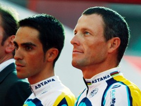 Astana rider Lance Armstrong of the U.S. stands on the podium with his team mate Alberto Contador of Spain during the team presentation ahead of the start of the 96th Tour de France cycling race in Monaco, in this July 2, 2009 file photo. (Charles Platiau/REUTERS Files)