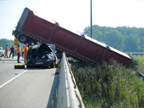 An OPP police cruiser was destroyed in a collision on Highway 402 at Modeland Road in Sarnia, Ont. on Aug. 24, 2012, where a tractor trailer struck the cruiser and skidded off the side of the embankment.(DANIEL PUNCH/QMI AGENCY)