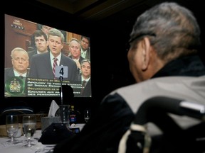 Former residential school student Joe Courtoreille watches a TV broadcast at the River Cree Resort and Casino in Enoch of Prime Minister Stephen Harper apologizing yesterday to victims of abuse at Indian residential schools across Canada.
