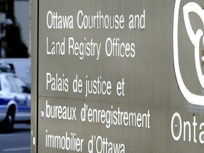 An Ottawa Police service vehicle drives past the Ottawa Courthouse heading north on Elgin Street in Ottawa, Ont.,  on Sept 30, 2004. (QMI Agency/SEAN KILPATRICK)