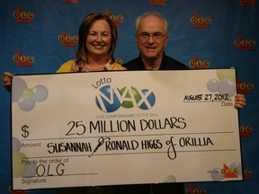 Susannah and Ron Higgs, of Orillia, pose with their $25-million cheque Monday. (Submitted photo)