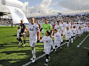 Vancouver Whitecaps walk out onto the pitch at Empire Field for their first MLS regular season game ever against Toronto FC on March 19, 2011. (Photo by Les Bazso, PNG)