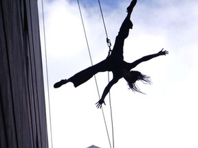 A dancer from Aeriosa rehearsing new work Being hanging outside the Scotibank Dance Centre