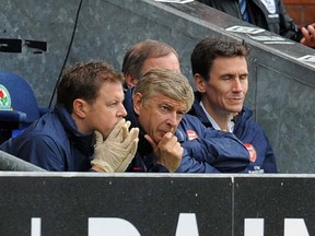 Arsenal's French manager Arsene Wenger (centre) watches the English Premier League football match between Blackburn Rovers and Arsenal at Ewood Park, Blackburn, north-west England on September 17 2011. (Andrew Yates, AFP/Getty Images)