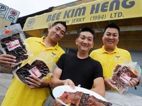 VANCOVUER, B.C.: SEPTEMBER 16, 2011 --Scott Lim (left) and Ray Lim (right) flank their father William Lim (center) who started BKH Singapore Style Beef & Pork Jerky 25 years ago in Vancouver September 16, 2011.

(Ric Ernst / PNG)

(Story by Jenny Lee)

TRAX #: Â 00055935A