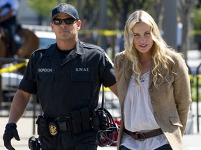 A Police officer arrests American actress Daryl Hannah during a protest against the construction of the Keystone XL pipeline, outside the White House in Washington, DC, August 30, 2011. Hannah was among dozens of protestors arrested in a demonstration against the oil pipeline which, if constructed, would run from Alberta's oilsands in Canada to Texas. AFP PHOTO / Saul LOEB (Photo credit should read SAUL LOEB/AFP/Getty Images)