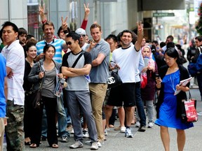 Customers line up outside the Apple Store at Pacific Centre Mall to be the first to purchase the new iPhone 4 in Vancouver BC., on July 30, 2010.
(Nick Procaylo/PNG)