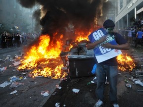 Fan holding Canucks poster at Stanley Cup Riot