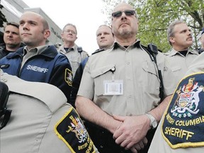 Sheriffs protest cuts to court services outside New Westminster Supreme Court.