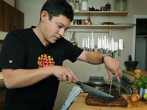 VANCOUVER, BC -- October  10,  2011 --  Chef Quang Dang prepares braised pork bellyand spicy tofu at his home in   Vancouver  on October 10, 2011.  He is executive chef at West.
(Wayne Leidenfrost/ PNG)
(For story by Juanita Ng)