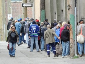 Homeless people line up for a bed at the Salvation Army in Vancouver