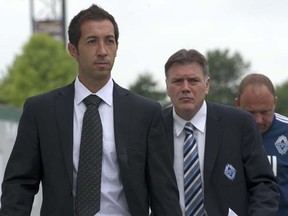 Incoming Vancouver Whitecaps head coach Martin Rennie (left) walks with team president Bob Lenarduzzi and outgoing interim coach Tom Soehn (right) to the news conference announcing Rennie’s hiring in August 2011. (Photo by Ward Perrin, PNG)
