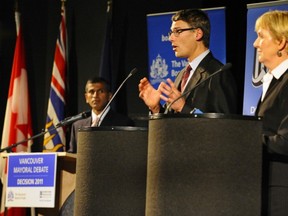 VANCOUVER, B.C.: OCTOBER 25,2011 - -A protestor interrupts  City of Vancouver Mayoralty  Vision candidate Mayor Gregor Robertson and Suzanne Anton, councillor and Non-Partisan Association candidate as participate in a head-to- head debate sponsored by the Vancouver Board of Trade and the Downtown Vancouver Association at the Goldcorp Centre for the Arts, SFU Campus in downtown Vancouver on Tuesday, October 25, 2011.

(Les Bazso / PNG staff photo)

(see PNG story )

00056813A  00056823A