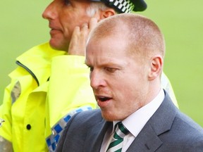 Celtic coach Neil Lennon is escorted by police after a recent game. Lennon is at the centre of a police investigation after a parcel bomb was sent to him and two other people. Jeff J Mitchell/Getty Images