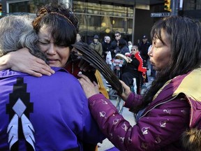 VANCOUVER, B.C.: OCTOBER 17, 2011 - Fresh grief from a similar tragedy with the announcement that Prince George RCMP have a suspect in the Highway 16 murders causes Cee Jay Julian(C) of Ft. St. James to be consoled by elders at the first nations healing circle supporting the families of the missing and murdered women in the intersection of  Granville and Georgia  Monday, October 17, 2011 in Vancouver, B.C.  ( Ian Lindsay /  PNG staff photo)