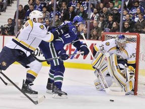 Vancouver Canucks Ryan Kesler(C) gets a check in the back from Shea Weber(L) of the Nashville Predators in the first period of  NHL action at Rogers Arena in Vancouver, October 20..   ( Ian Lindsay /  PNG staff photo)