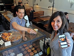 Maura Rodgers, founder of Urbandig at the Revolver Coffee shop with George Giannakos , a tiny new coffee shop on Cambie St. and one featured in the tours on the app guidefor travelers to those off-the-beaten-path spots they might otherwise never find. (Les Bazso / PNG staff photo)