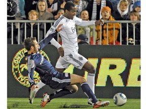 Vancouver Whitecap Atiba Harris tries to fend off New England Revolution defender A.J. Soares in a Major League Soccer game last spring at Empire Field in Vancouver. (Photo by Ian Lindsay, PNG)