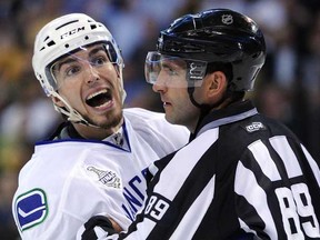 Vancouver Canucks winger Alex Burrows (left) isn't short on sharing his opinions, even including his CFL picks. (Photo by Harry How, Getty Images)