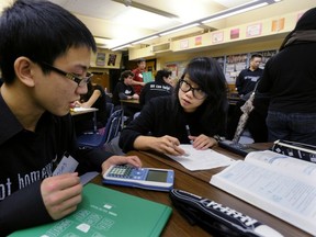 Christina Wong, 17, gets some Grade 12 math help from SFU tutor Moses To, 18, at Britannia Secondary School. Photo by Stuart Davis, PNG