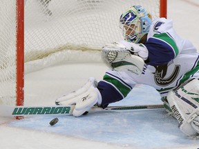 DENVER, CO - NOVEMBER 23:  Goalie Cory Schneider #35 of the Vancouver Canucks makes a save against the Colorado Avalanche at the Pepsi Center on November 23, 2011 in Denver, Colorado. Schneider had 24 saves as the Canucks shoutout the Avalanche 3-0.  (Photo by Doug Pensinger/Getty Images)