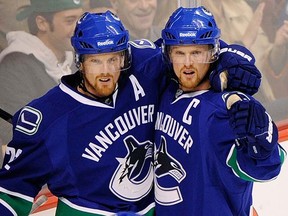 The Canucks again are looking to Daniel (left) and Henrik Sedin to lead them. (Photo by Ric Ernst, PNG)