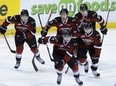 Giants left winger Cain Franson leads teammates back to bench for high fives after scoring opening goal against Oil Kings on Wednesday. (photo by Mark van Manen, PNG)