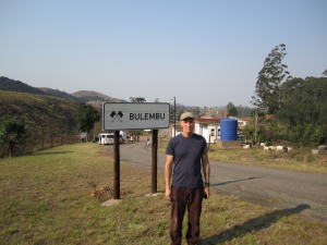 John beside Bulembu town sign