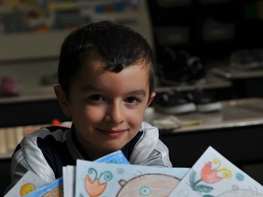 EDMONTON, AB. NOVEMBER  10,  2011 - Logan Ketteringham is surrounded by thank-you letters from students at Admiral Seymour Elementary School in Vancouver. SHAUGHN BUTTS/EDMONTON JOURNAL)