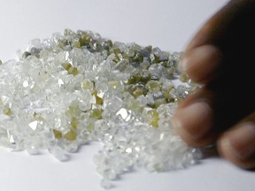 A picture taken on August 10, 2007 shows a man checking raw diamonds at a bank in Freetown.   (ISSOUF SANOGO/AFP/Getty Images)