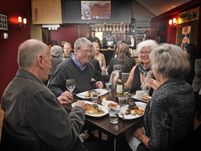 VANCOUVER, B.C.: DECEMBER 02, 2011 - Diners enjoy their entrees while in the background Chef Karl Gregg cooks in the small galley kitchen at the Founders' Lounge cafe inside the Vancouver East Cultural Centre Friday, December  02, 2011in Vancouver, B.C.
(Ian Lindsay/ PNG)
(Sun story by Mia Stainsby)