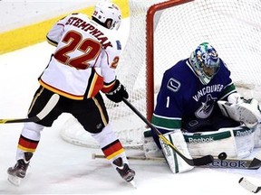 Calgary Flames right wing Lee Stempniak (22) tries to get a shot past Vancouver Canucks goalie Roberto Luongo (1) during second period NHL hockey action at Rogers Arena in Vancouver, British Columbia Friday, Dec, 23, 2011. (AP Photo/The Canadian Press, Jonathan Hayward)