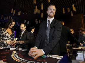 Working the room, Vancouver Canucks star Daniel Sedin deals out the cards during the team’s annual Dice & Ice fundraiser at the Vancouver Convention Centre on Thursday. (Photo by Mark van Manen, PNG)