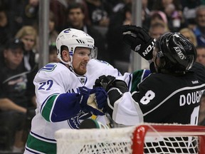 LOS ANGELES, CA - DECEMBER 31:  Daniel Sedin #22 of the Vancouver Canucks shoves Drew Doughty #8 of the Los Angeles Kings after the whistle in the third during the NHL game at Staples Center on December 31, 2011 in Los Angeles, California. The Kings defeated the Canucks 4-1. (Photo by Victor Decolongon/Getty Images)