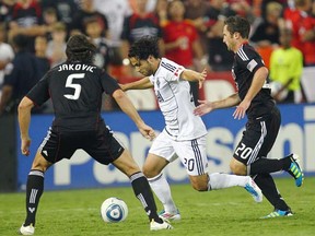 Vancouver Whitecap Davide Chiumiento dribbles his way through the D.C. United defence during an MLS game last season. An early-season visit from the U.S. capital city team will be a key fixture if the Caps want to make their fans forget a disappointing 2011 expansion campaign. (Photo by Ned Dishman, Getty Images)