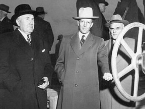 &ampgt;Alberta Premier Ernest Manning (centre) and Canada's industry minister, C.D. Howe (right), turned the valve that started black gold flowing from Alberta along the Interprovincial Pipe Line in 1950.