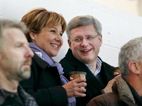 Prime Minister Stephen Harper joins Premier Christy Clark for a photo op at Clark's son's hockey game.