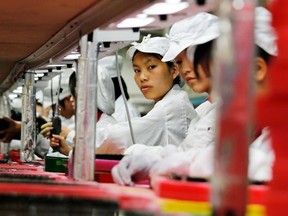 Workers are seen inside a Foxconn factory in the township of Longhua, southern Guangdong province May 26, 2010. Picture taken May 26, 2010.