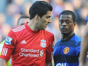 Liverpool's Uruguayan forward Luis Suarez (left) exchanges words with Manchester United's French defender Patrice Evra during an Oct. 15, 2011 English Premier League soccer match at Anfield in Liverpool, England. (Photo by Andrew Yates, AFP)