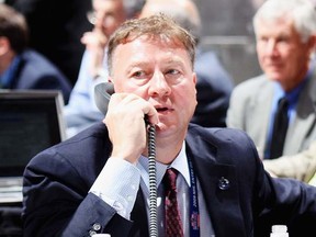 Vancouver Canucks general manager Mike Gillis works the phones at the 2009 NHL Entry Draft in Montreal. (Photo by Bruce Bennett, Getty Images)