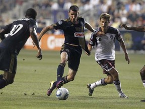 The Philadelphia Union's Sebastien Le Toux gets his jersey tugged by Colorado Rapids forward Conor Casey (right) during a July 2011 Major League Soccer game in Chester, Pa. (Photo by Ron Cortes, MCT)