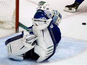 Vancouver Canucks goalie Cory Schneider dives across the crease to make a glove save on a Chicago Blackhawks shot during the second period of an NHL hockey game in Vancouver, British Columbia, on Tuesday, Jan. 31, 2012. (AP Photo/The Canadian Press, Darryl Dyck)