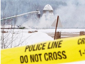 More than 92 per cent of the workplace fatalities in B.C. in 2011 were men, a proportion that mirrors national trends. In this photo smoke rises as police tape surrounds the Babine Forest Products mill, which exploded in Burns Lake, B.C., on Jan. 21, 2012. So far no charges have been laid.