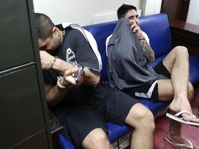 Ali Shirazi and James Riach before court appearance in Manila Thursday