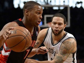 Toronto Raptors point guard Kyle Lowry (left) drives past Brooklyn Net Deron Williams during their NBA game Monday at the Barclays Center in New York.