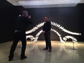 Nick Procaylo photographing curator Doug Lewis in front of Bridge by Xiaojing Yan