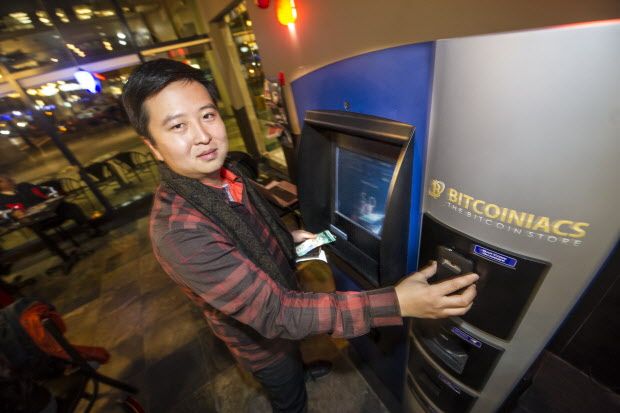 Mike Yeung at the world's first Bitcoin ATM at Waves Coffee shop at Smithe and Howe  in Vancouver, B.C. (Steve Bosch/PNG staff photo)       