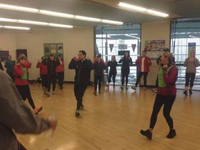 Leader Arian Soheili, with help from sisters Tracy (right) and Kellie (left) lead their Sun Run InTraining Clinic participants through a laugh- and fun-filled warmup in Langley.