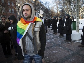 A Russian gay rights activist walks along a police line during a rally at a Moscow boulevard. (AP Photo/ Alexander Zemlianichenko, file)